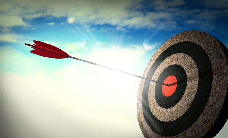 Archery target with a single arrow in the bullseye