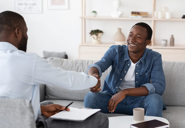 Therapist shaking hands with his patient after using the standard of care and his professional judgment to create a treatment plan they both agree on.