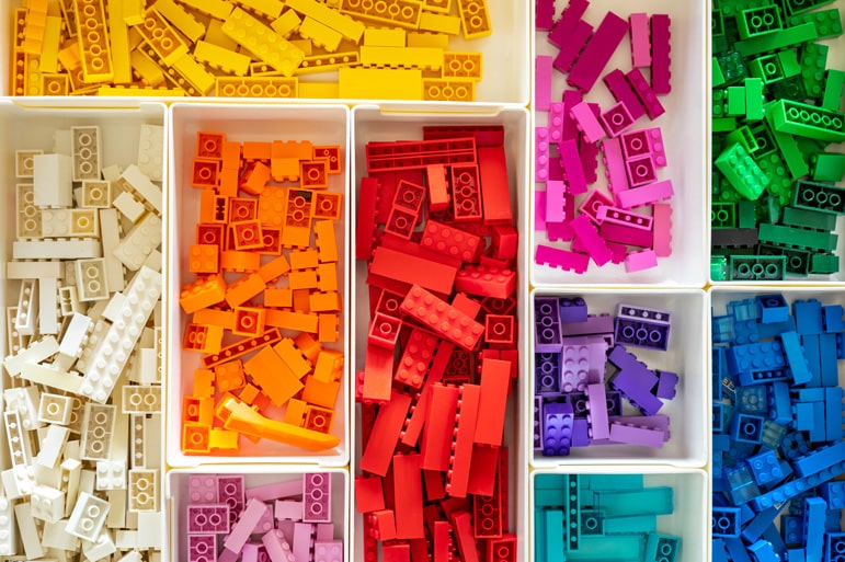 Multicolored Lego Classic blocks sorted by color in an organized drawer.