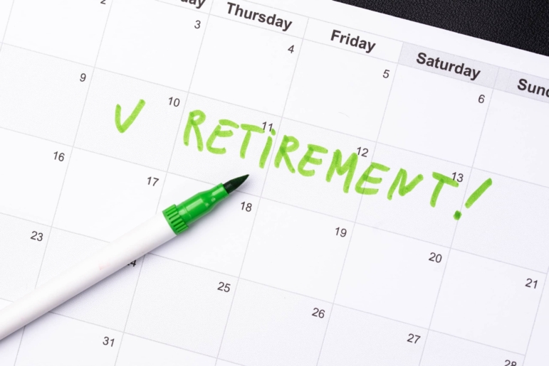 Calendar page with a green marker and a green check mark, the word “RETIREMENT!” handwritten across the dates.