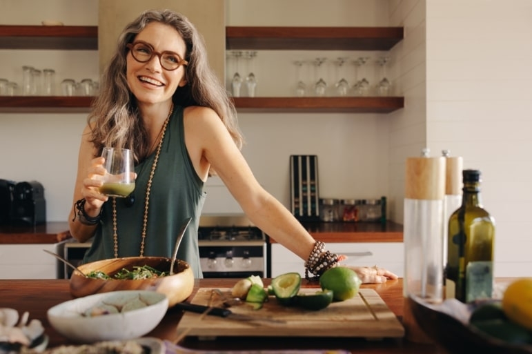Person preparing a fresh, healthy meal in a home kitchen, reflecting mindful food choices and balanced eating habits.